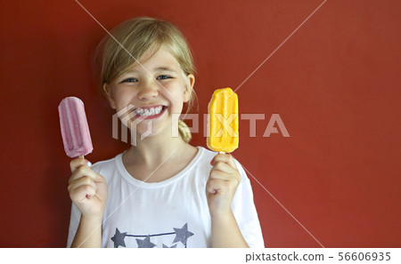 Little blond girl eating ice cream 56606935