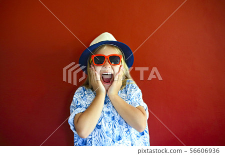 Pretty emothional child wear a hat and sunglasses 56606936
