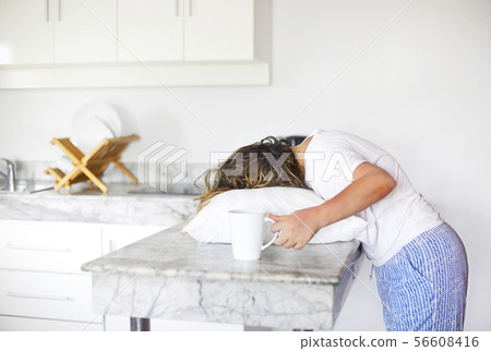 Sleppy woman with cup of coffee and pillow on the Sleppy woman with cup of coffee and pillow on the 56608416