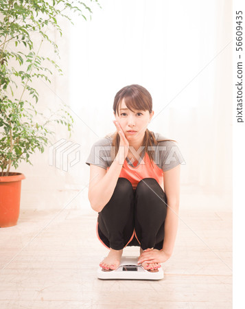 A woman who is losing weight A woman who is losing weight 56609435