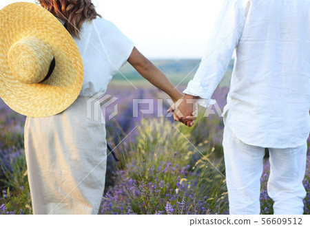 Cute young happy couple in love in a field of Cute young happy couple in love in a field of 56609512