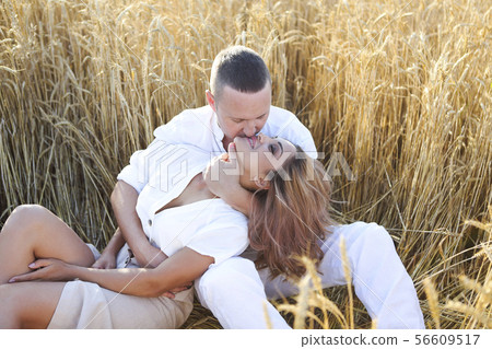 Happy couple in love in wheat field 56609517