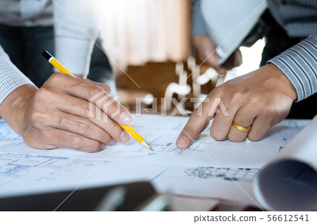 Confident engineer team working with Blue Print Confident engineer team working with Blue Print 56612541