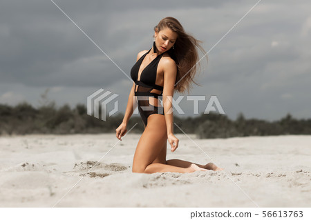 Gorgeous young female crawling on beach Gorgeous young female crawling on beach 56613763