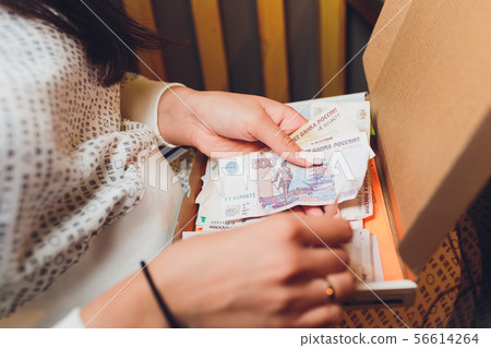 Russian rubles in the hand of a fan.male hand holding many of the Russian banknotes.The transfer of Russian rubles in the hand of a fan.male hand holding many of the Russian banknotes.The transfer of 56614264