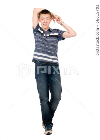 Cheerful young man in full growth isolated over Cheerful young man in full growth isolated over 56615703