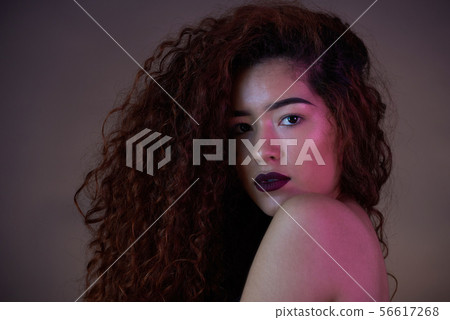 Headshot of curly hair young girl Headshot of curly hair young girl 56617268
