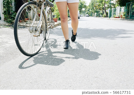 Woman with her bicycle Woman with her bicycle 56617731