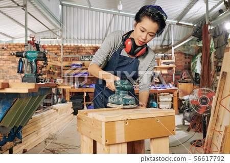 Carpenter polishing wooden surface Carpenter polishing wooden surface 56617792