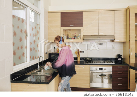 Senior woman waching dishes Senior woman waching dishes 56618142