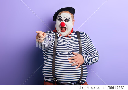 crazy artist indicates with finger , close up photo. 56619381