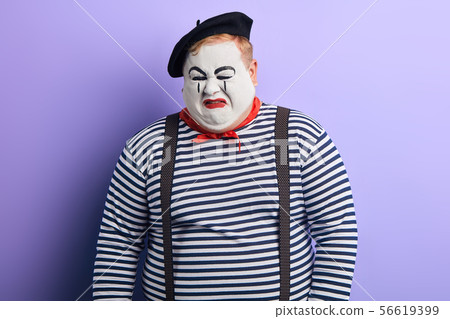 crying mime wearing striped sweater, beret 56619399