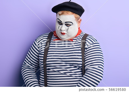 portrait of a sad unhappy depressed clown looking down over blue background portrait of a sad unhappy depressed clown looking down over blue background 56619580