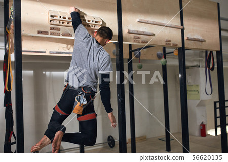 Boulderer with physical disability doing exercises at special wooden platform Boulderer with physical disability doing exercises at special wooden platform 56620135