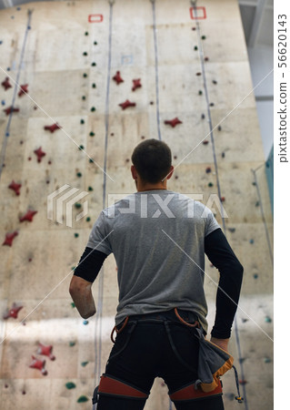 Man with physical disability preparing to bouldering training in indoor settings Man with physical disability preparing to bouldering training in indoor settings 56620143