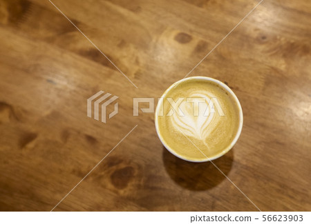 Paper cup of cafe latte on wooden table background Paper cup of cafe latte on wooden table background 56623903