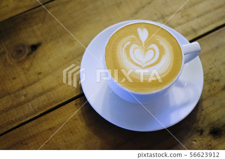Cups of cafe latte on wooden table background Cups of cafe latte on wooden table background 56623912