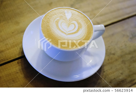 Cups of cafe latte on wooden table background Cups of cafe latte on wooden table background 56623914