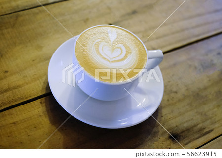 Cups of cafe latte on wooden table background Cups of cafe latte on wooden table background 56623915