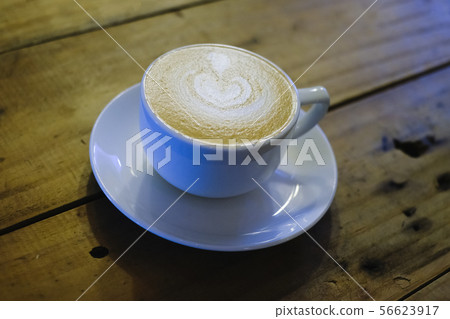 Cups of cafe latte on wooden table background Cups of cafe latte on wooden table background 56623917