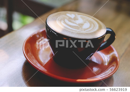 Cups of cafe latte on wooden table background Cups of cafe latte on wooden table background 56623919