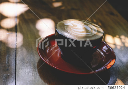 Cups of cafe latte on wooden table background Cups of cafe latte on wooden table background 56623924