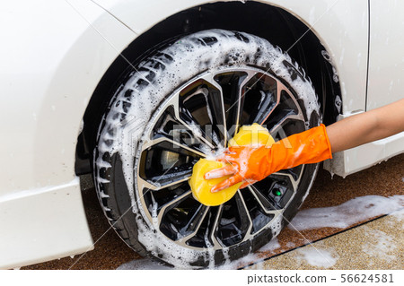 Woman hand wearing orange gloves with yellow  56624581