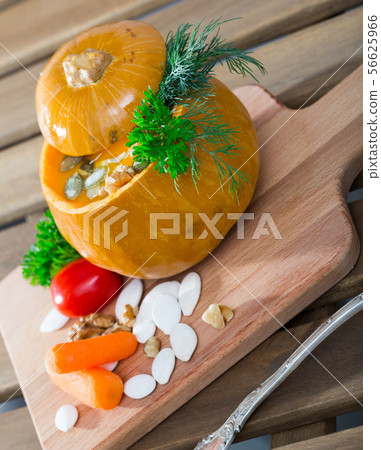 Cooked homemade tasty pumpkin cream soup served in pumpkin 56625966