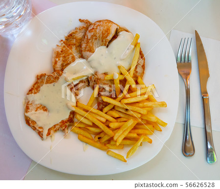 Top view of pork tenderloins with fried potatoes Top view of pork tenderloins with fried potatoes 56626528