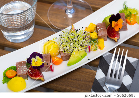 Fried tuna with fruits, vegetables and greens 56626695