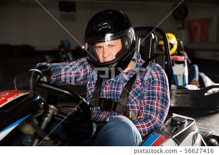 Portrait of happy man driving racing car 56627416