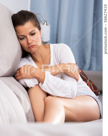 Frustrated woman on sofa 56627419