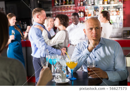 Worried businessman at corporate party Worried businessman at corporate party 56627573