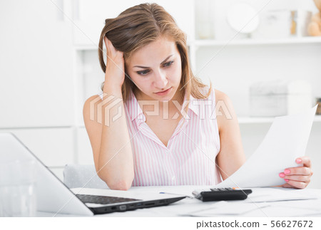 Disappointed girl worried about bills Disappointed girl worried about bills 56627672