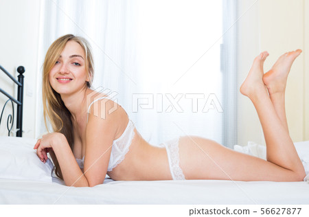 Seductive young woman in underwear at bedroom 56627877