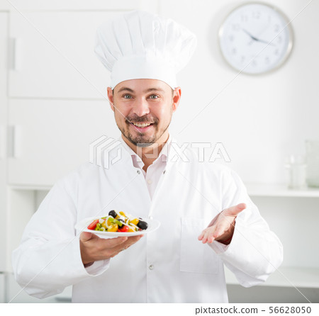 Positive cook with greek salad Positive cook with greek salad 56628050