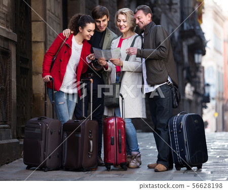Portrait of tourists with map and baggage seeing the sights in European city Portrait of tourists with map and baggage seeing the sights in European city 56628198