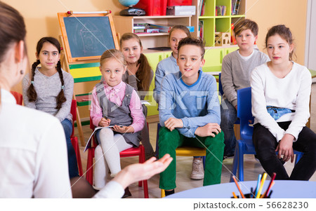 Portrait of pupils listening teacher at lesson in elementary school 56628230