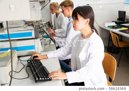 Students performing experiments in laboratory 56628369