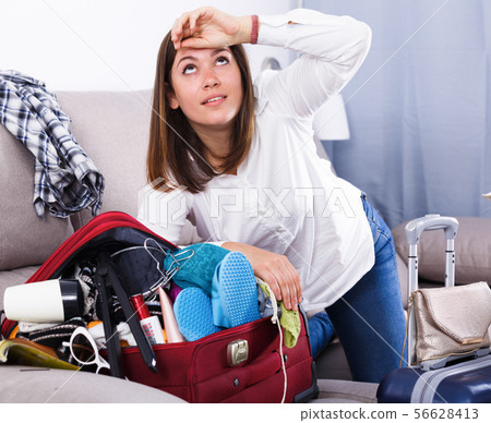 Woman packing for holiday 56628413