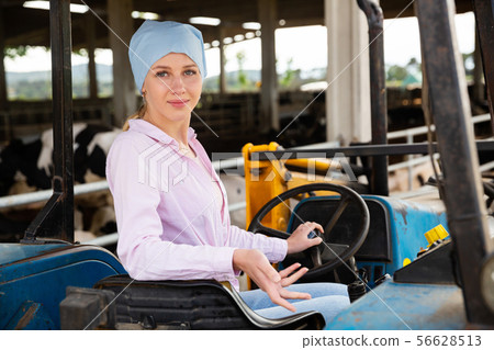 Young woman proffesional farmer is sitting in the car at the farm 56628513