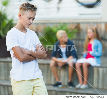 Upset boy after quarrel with playmates 56628561