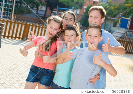 Glad kids posing at the playground and thumbs up Glad kids posing at the playground and thumbs up 56628588