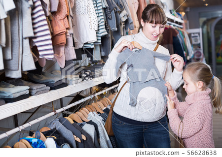 woman with her daughter buy the sliders to the girls woman with her daughter buy the sliders to the girls 56628638