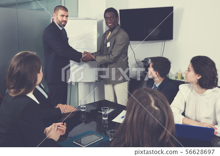 Strong shaking hands of two partners as sign of closing deal Strong shaking hands of two partners as sign of closing deal 56628697