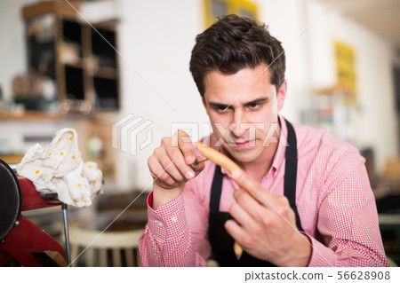 Craftsman in uniform working in carpentry 56628908