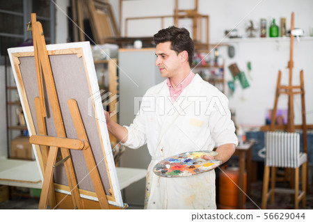 Artist painting on canvas Artist painting on canvas 56629044