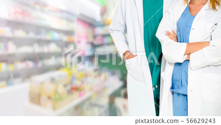 Pharmacist working with colleague in pharmacy. Pharmacist working with colleague in pharmacy. 56629243