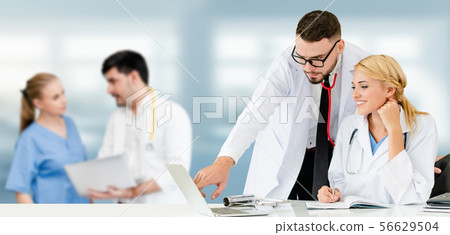 Doctor working in hospital with other doctors. Doctor working in hospital with other doctors. 56629504