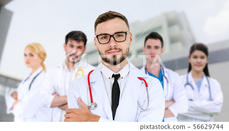 Doctor working in hospital with other doctors. 56629744